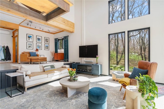 living room with a towering ceiling and beamed ceiling