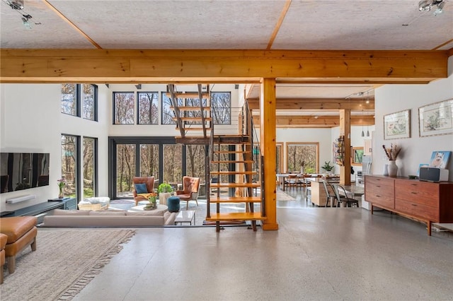 living area featuring stairway and speckled floor
