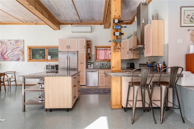 kitchen featuring light brown cabinets, stainless steel appliances, backsplash, a wall mounted AC, and a peninsula