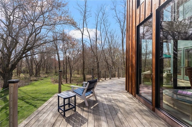 wooden deck featuring a lawn