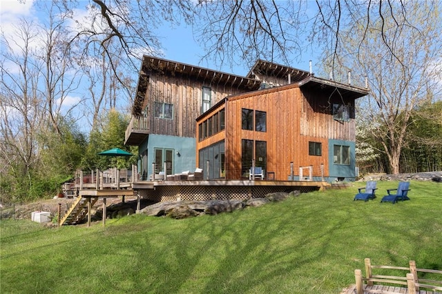 back of house featuring a wooden deck and a yard