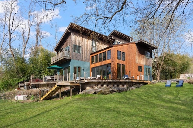 rear view of property with stairway, a wooden deck, a balcony, and a yard