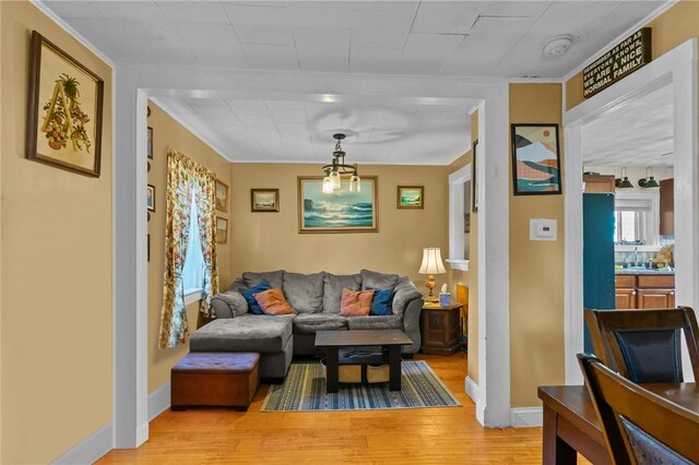 77 Seamans St, Providence, RI 02908 - living room featuring light wood finished floors, baseboards, and ornamental molding