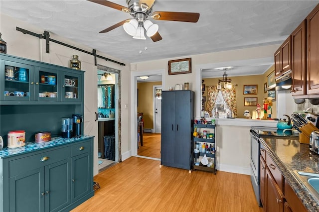 77 Seamans St, Providence, RI 02908 - kitchen with ceiling fan, light wood-style flooring, stainless steel electric range oven, under cabinet range hood, and dark countertops