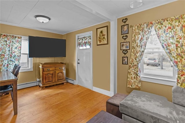 77 Seamans St, Providence, RI 02908 - foyer featuring baseboards, light wood-style flooring, a baseboard radiator, and ornamental molding