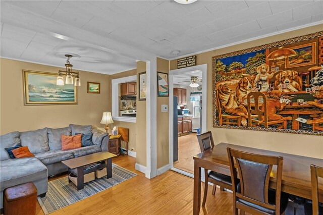 77 Seamans St, Providence, RI 02908 - living area featuring ceiling fan, light wood finished floors, baseboards, and ornamental molding