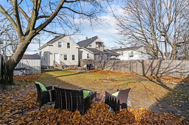 77 Seamans St, Providence, RI 02908 - view of yard featuring entry steps, fence, a fire pit, and an outdoor structure