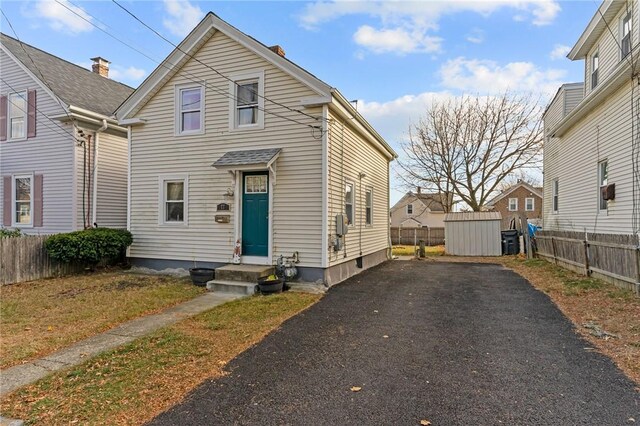 77 Seamans St, Providence, RI 02908 - view of front of home with aphalt driveway, entry steps, and fence