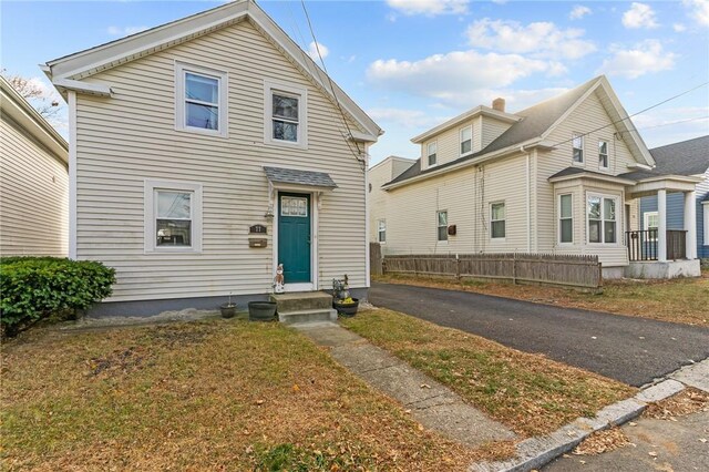 77 Seamans St, Providence, RI 02908 - view of front of house featuring entry steps, a chimney, and fence