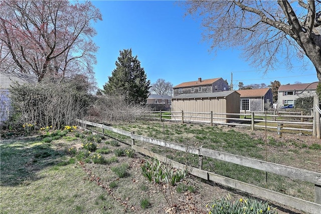 view of yard featuring an outdoor structure and fence
