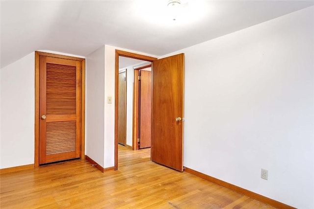 unfurnished bedroom with light wood-type flooring and baseboards