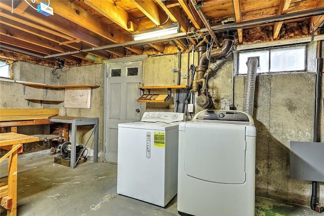 washroom with a sink, washing machine and clothes dryer, and laundry area