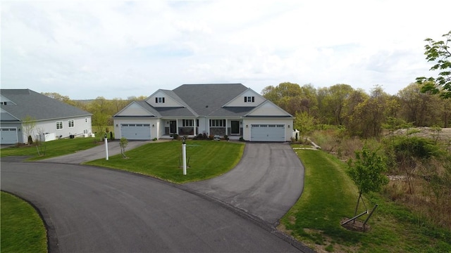 traditional home featuring a front yard, driveway, and a garage