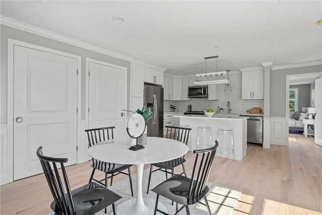 0 Greenwich Blvd Unit 102, East Greenwich, RI 02818 - dining area featuring light wood-style floors and crown molding