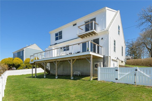 back of house featuring a gate, a yard, a wooden deck, and fence