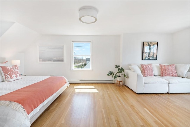 bedroom featuring baseboard heating and wood finished floors