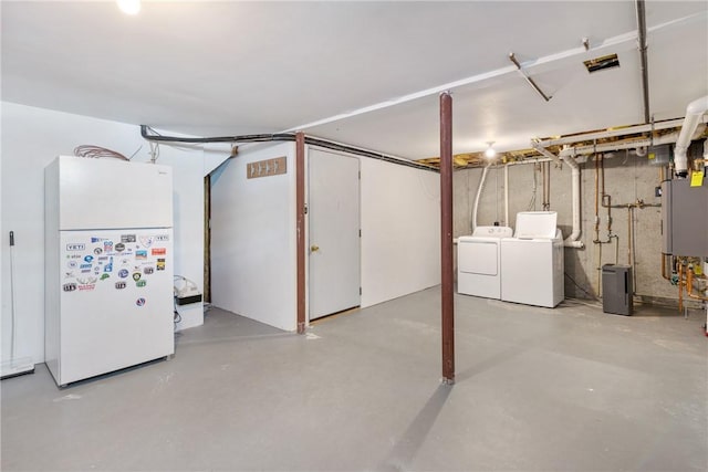 unfinished below grade area with freestanding refrigerator and washer and clothes dryer