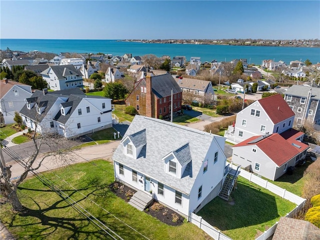 birds eye view of property with a water view and a residential view