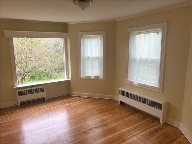 196 Columbia St, South Kingstown, RI 02879 - unfurnished room featuring light wood finished floors, ornamental molding, radiator, and baseboards