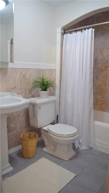 33 Almy St, Newport, RI 02840 - full bath with tile patterned floors, shower / bathtub combination with curtain, tile walls, and toilet