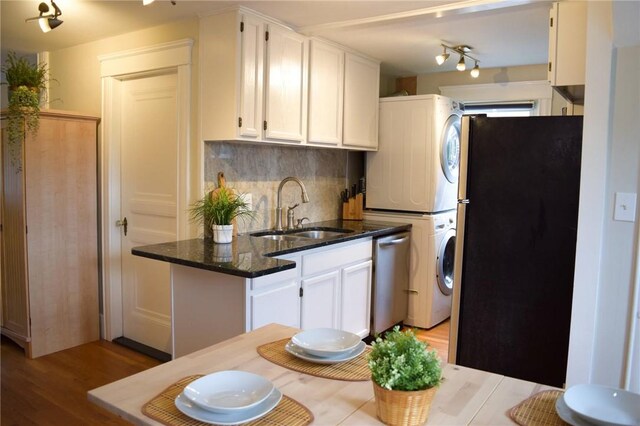 33 Almy St, Newport, RI 02840 - kitchen featuring stacked washer and dryer, white cabinets, decorative backsplash, stainless steel appliances, and a sink