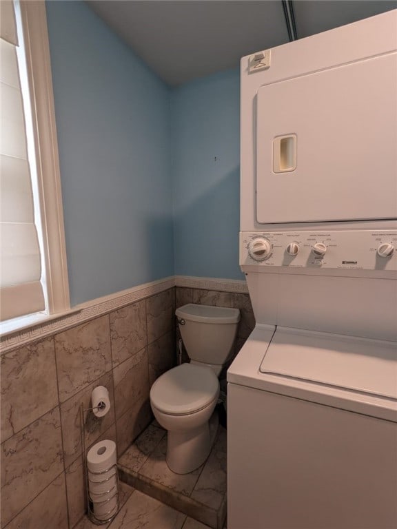 33 Almy St, Newport, RI 02840 - bathroom with wainscoting, stacked washer / drying machine, tile walls, and toilet