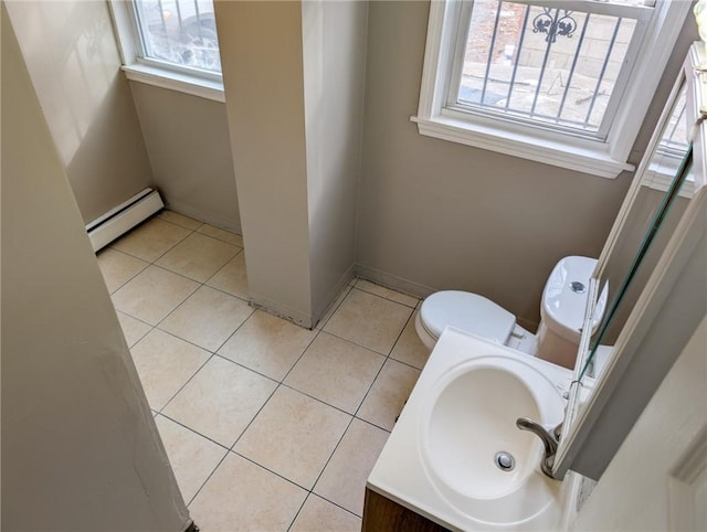17 Marietta St, Providence, RI 02904 - bathroom featuring tile patterned floors, baseboard heating, toilet, and a healthy amount of sunlight