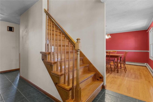 stairs with tile patterned floors, baseboards, and a baseboard radiator