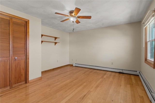 unfurnished bedroom with a baseboard radiator, light wood finished floors, baseboards, and a ceiling fan