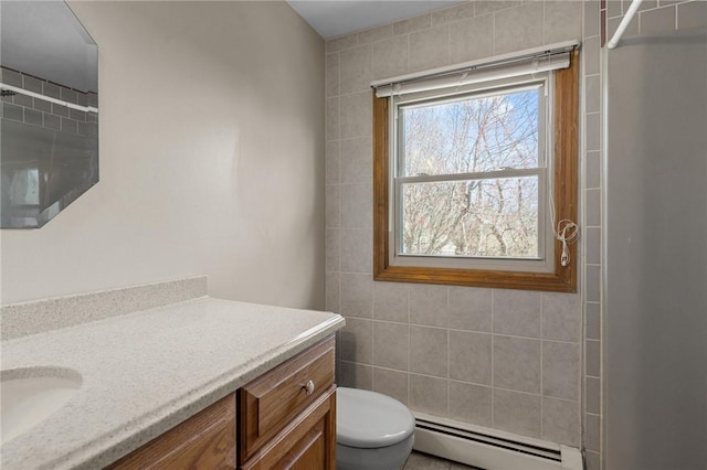 full bath featuring toilet, a baseboard heating unit, vanity, and walk in shower