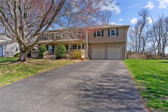 view of front of home featuring aphalt driveway, a porch, an attached garage, and a front yard