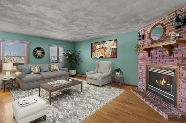 living room with a baseboard radiator, a textured ceiling, and wood finished floors