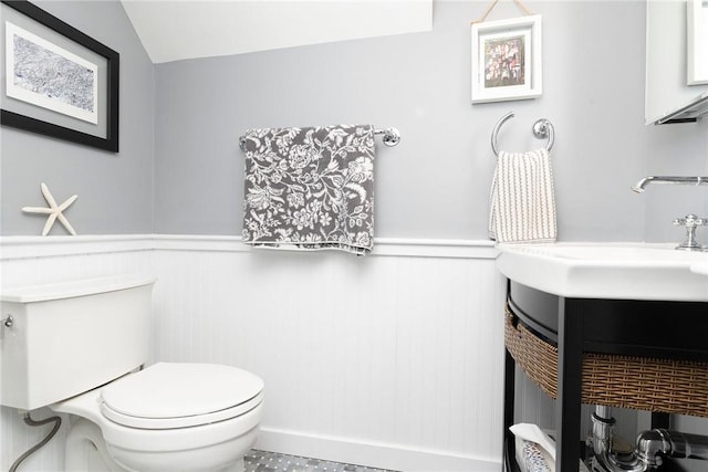 1597 Main Rd, Tiverton, RI 02878 - bathroom with vanity, toilet, a wainscoted wall, and vaulted ceiling