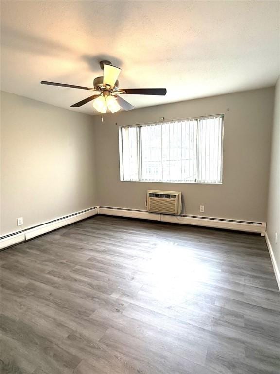 53 Urban Ave Unit 6, North Providence, RI 02904 - unfurnished room with a ceiling fan, dark wood finished floors, baseboards, and an AC wall unit