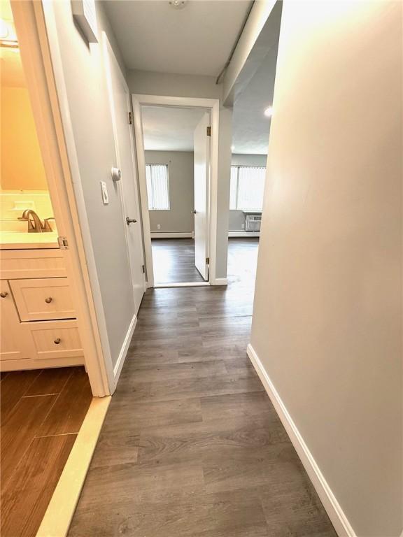 53 Urban Ave Unit 6, North Providence, RI 02904 - corridor with a sink, baseboards, a baseboard radiator, and dark wood-style floors