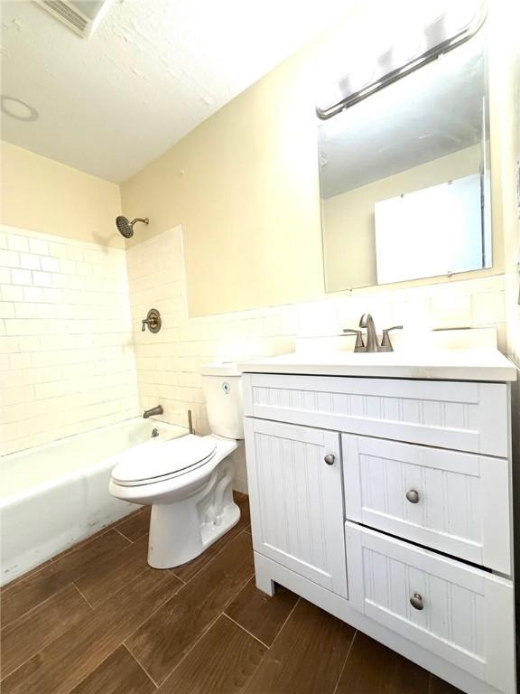 53 Urban Ave Unit 6, North Providence, RI 02904 - full bathroom with vanity, toilet, shower / bath combination, wood finished floors, and tile walls