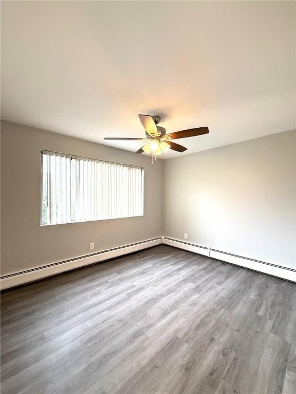 53 Urban Ave Unit 6, North Providence, RI 02904 - unfurnished room featuring a ceiling fan, wood finished floors, and baseboard heating
