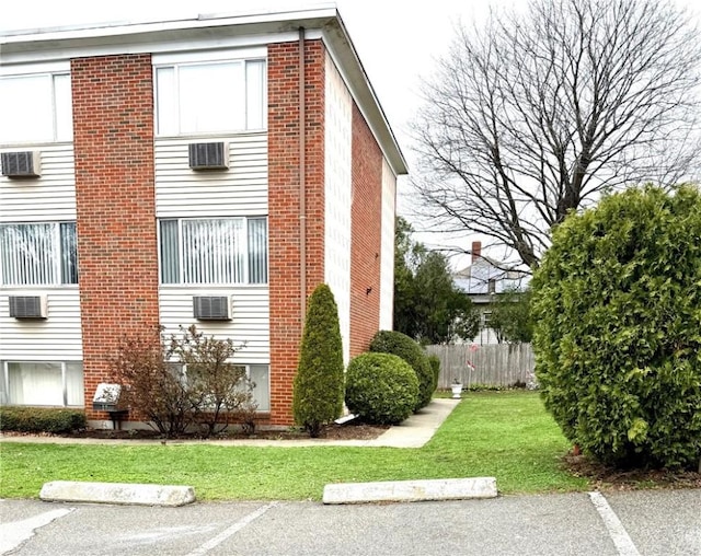 53 Urban Ave Unit 6, North Providence, RI 02904 - view of side of property with a yard, uncovered parking, and fence