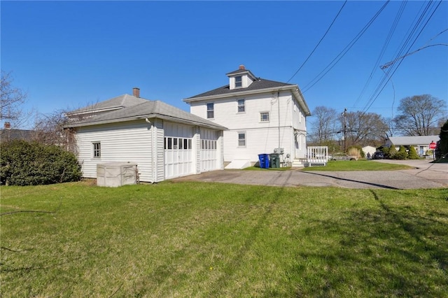 rear view of property with a lawn
