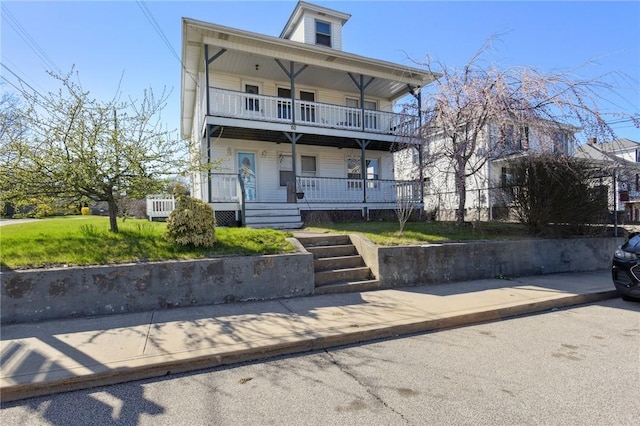 view of property with a porch and a balcony