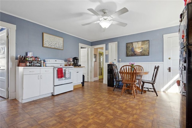 kitchen featuring crown molding, white electric stove, a ceiling fan, and white cabinetry