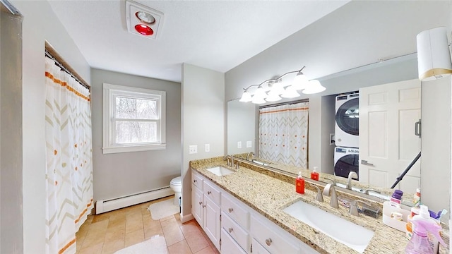 bathroom with stacked washing maching and dryer, a baseboard radiator, a sink, and toilet