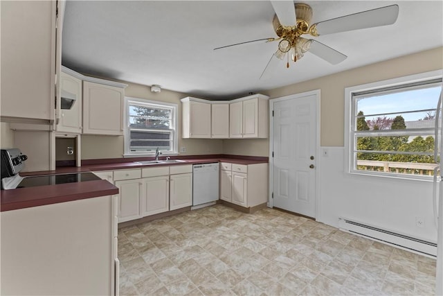 345 Post Rd, Warwick, RI 02888 - kitchen with dishwasher, a sink, dark countertops, stove, and a baseboard heating unit