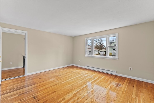 345 Post Rd, Warwick, RI 02888 - unfurnished room with a baseboard radiator, light wood finished floors, and baseboards