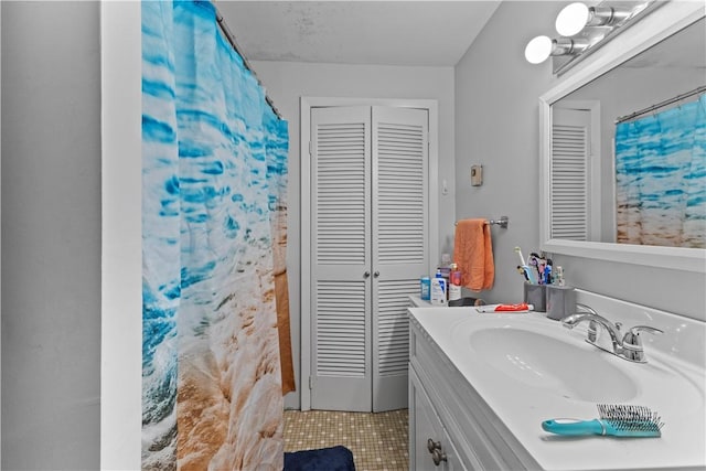345 Post Rd, Warwick, RI 02888 - bathroom with a closet, vanity, and tile patterned flooring