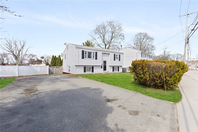 345 Post Rd, Warwick, RI 02888 - raised ranch with aphalt driveway, fence, and a front lawn