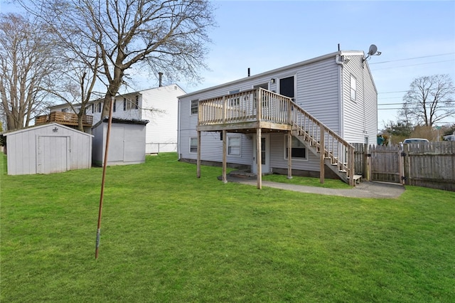 345 Post Rd, Warwick, RI 02888 - rear view of house with an outdoor structure, stairs, a storage shed, fence, and a lawn