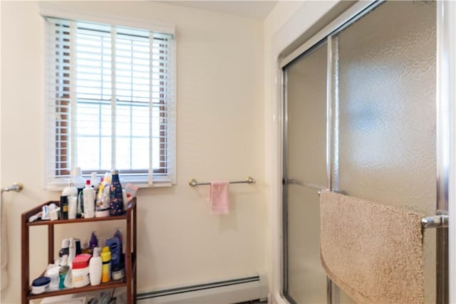 bathroom featuring a shower stall and a baseboard heating unit
