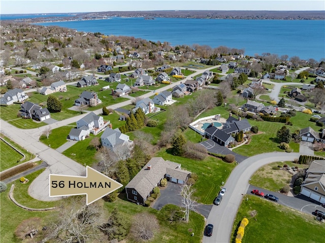 drone / aerial view featuring a residential view and a water view