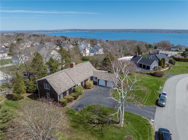 bird's eye view with a water view and a residential view